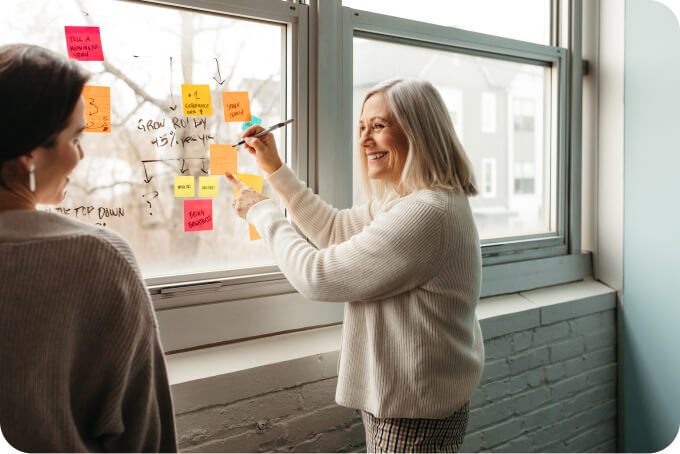 Woman putting notes on a window.