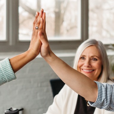 Two people giving each other an high five.