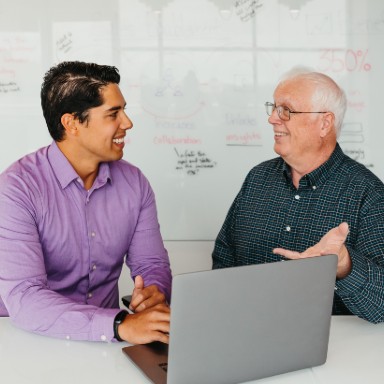 Two seated men having a conversation.