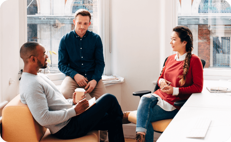 Three people chatting during a meeting