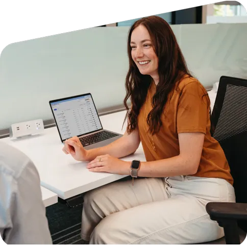 A smiling banking rep in conversation with an unseen person.