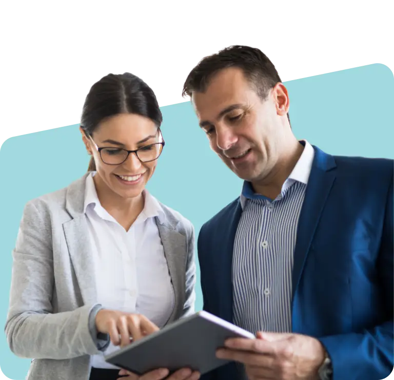 Two smiling people looking at tablet.