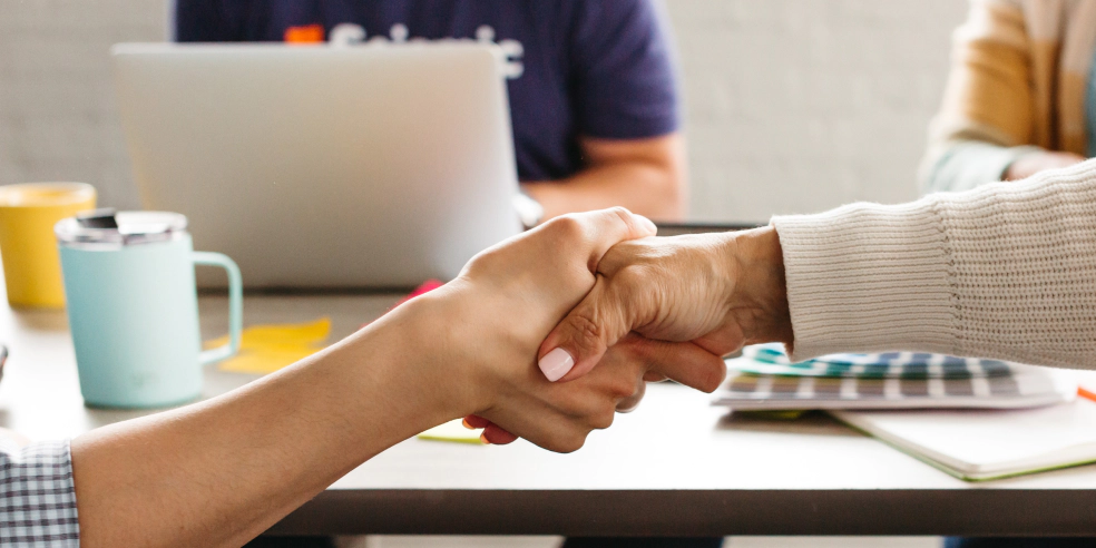 Close up of two people shaking hands.