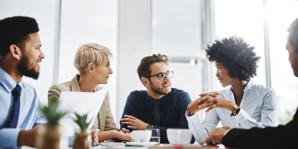 Small sales teams meeting in an office.