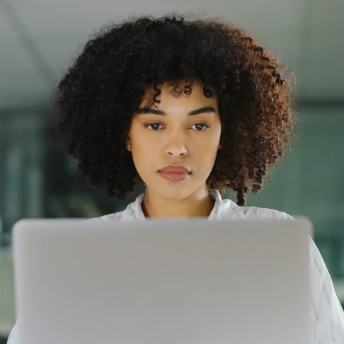 A young businesswoman using a laptop in a modern office