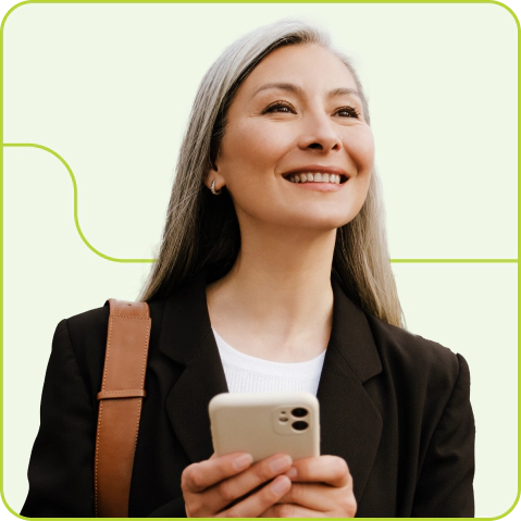 A smiling woman holding a mobile phone.